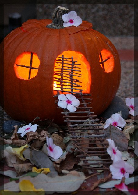 Fairy home pumpkin with twig windows and door and flower decorations Twig windows and doors for this pumpkin fairy home