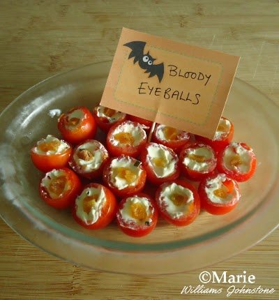Cherry tomatoes halved and stuffed with cream cheese filling