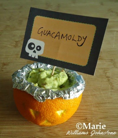 Guacamole dip served up as Guacamoldy in carved orange fruit
