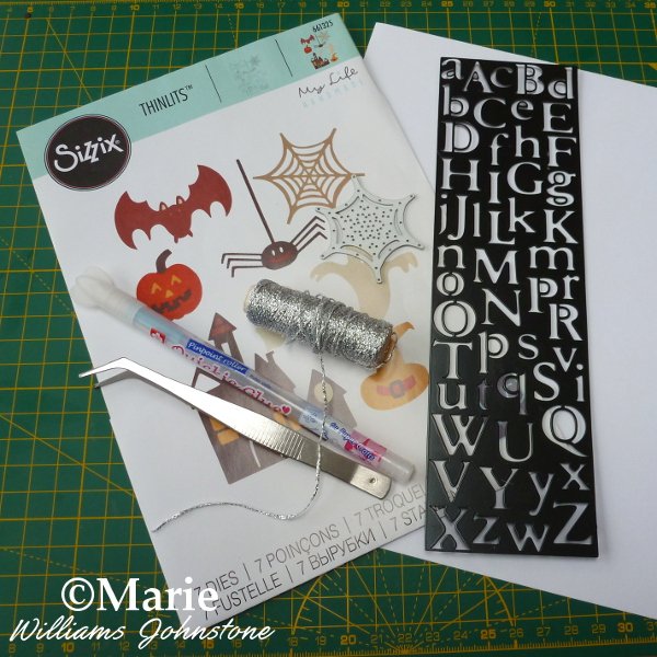 Tools materials to make a spiderweb banner craft Sizzix Halloween Thinlits dies alphabet glue pen cord
