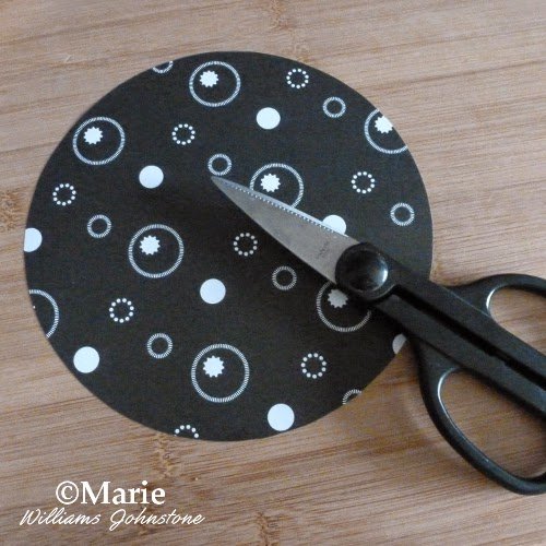 Black and white design of paper cut into a circle