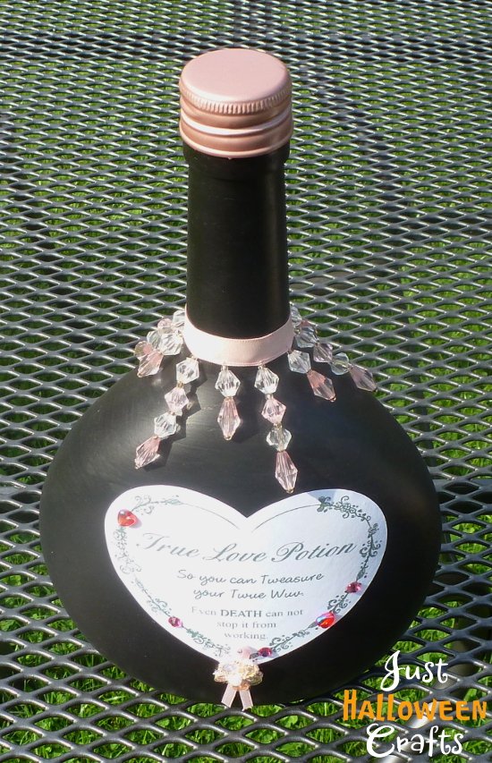 Black bottle with heart shaped label for true love apothecary design