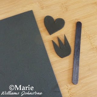 Black heart and trident shape cut from black craft foam and a stick