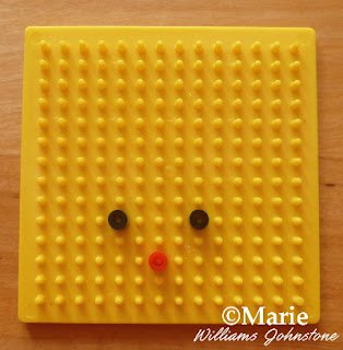 Yellow pegboard with fused perler beads