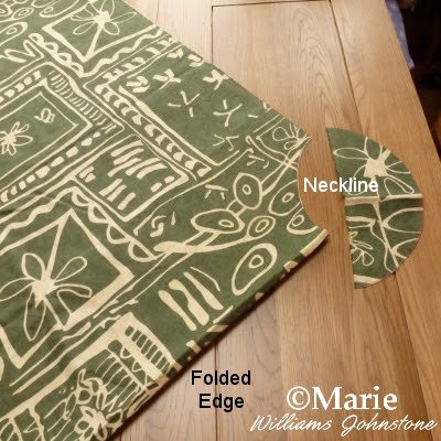 The neck section cut away from the folded fabric