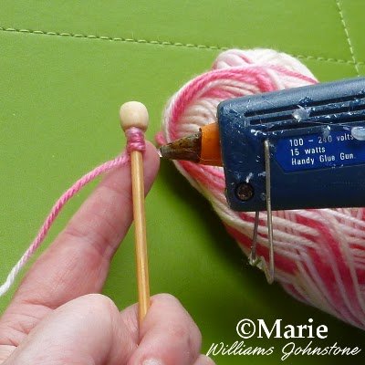 Attaching yarn to a wooden stick with a glue gun