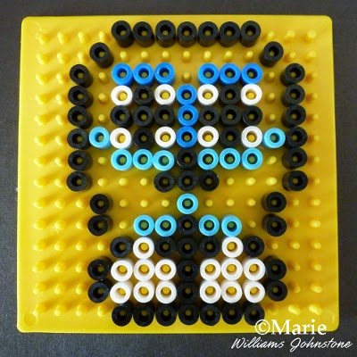 Yellow pegboard with design in black, white and blue colors