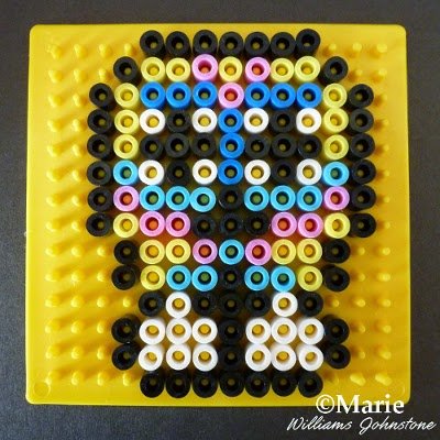Colorful perler hama beaded sugar skull pattern tutorial Using a square pegboard to make a design for Halloween