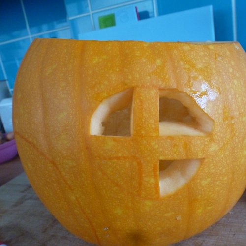 Orange Halloween pumpkin windows being carved