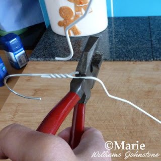 Use wire cutters to snap through a clothes hanger