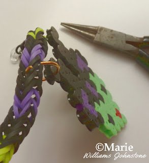 Jewelry pliers and an open jump ring are used to attach a charm