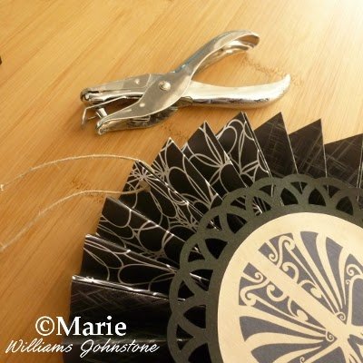 Hole punch making a hole for twine or cord to hang up this design