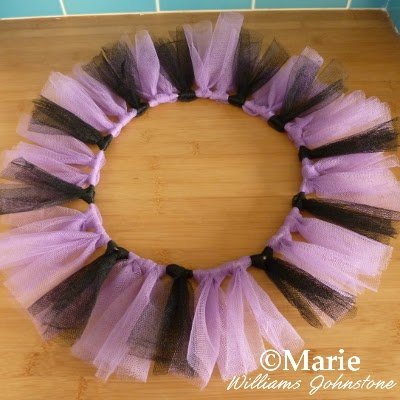 Black and purple strips attached to a diy wire base