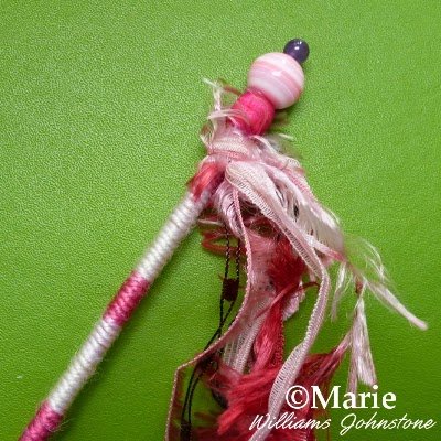 Detail of pink costume kids play wand with ribbons and beads