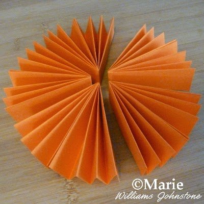 5 pieces of paper used to make a shaped decoration