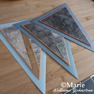 3 triangular paper flag bunting sections in grays, blacks and orange colors