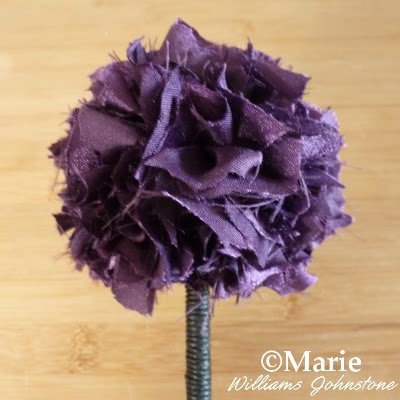 Purple satin fabric topper on a black homemade wand
