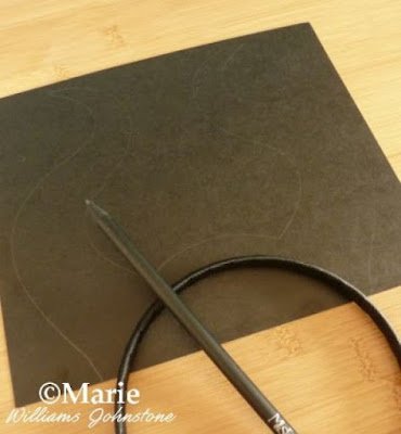 Black card and pencil to make a costume headband 