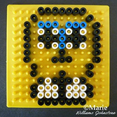 Black, white and blue fused beads outlining pattern design