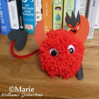 Completed pom pom pet made to look like a little devil character