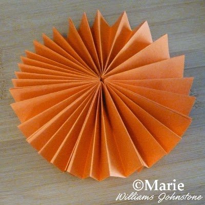 Folded round circular paper decoration for hanging up