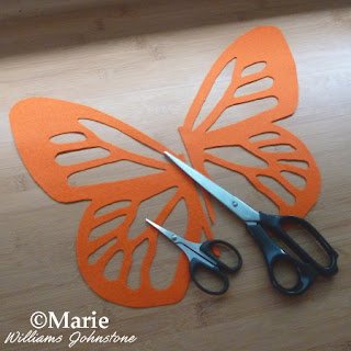 Orange butterfly wings and craft scissors