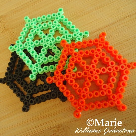 Completed Spiderweb Perler Bead Designs in Halloween Colors Green Black Orange Spiders Craft Spider Webs Cobwebs