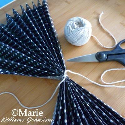Black folded tissue tied around the center with some thick string
