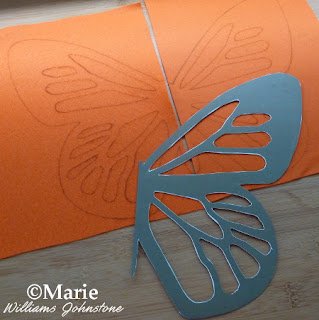 Orange felt sheets with traced butterfly design