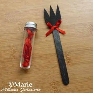 Black trident spear with red satin bow embellishment